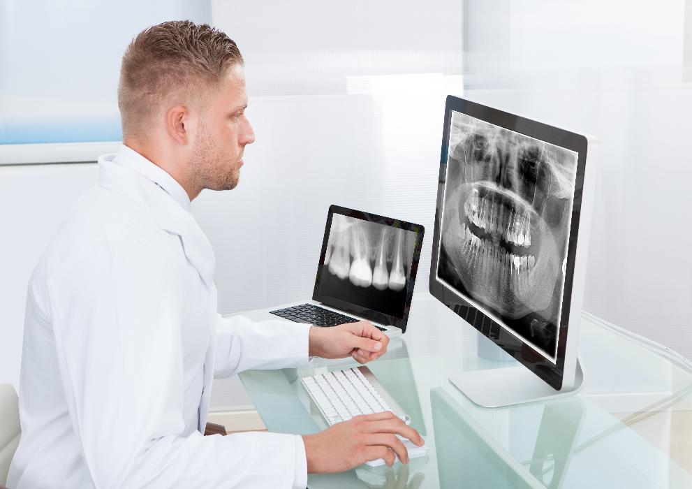 dentist looking at x-rays | emergency dentist narre warren