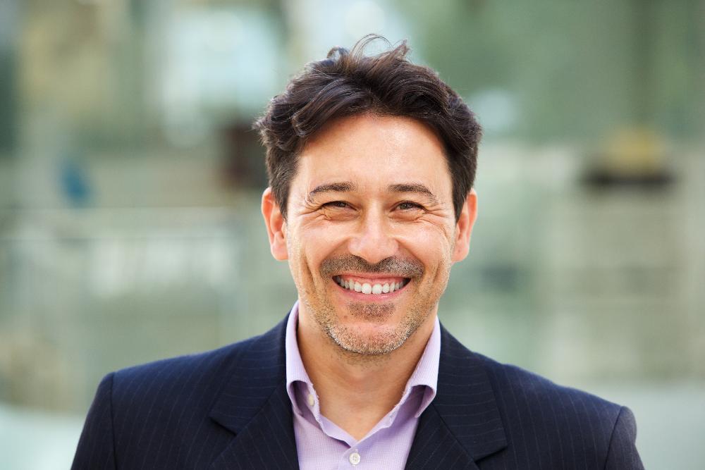 man with black hair smiling | dental implants narre warren