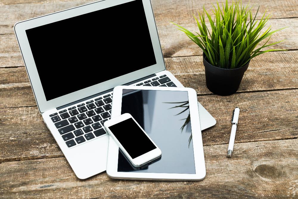 laptop and tablet on table | dentist near me