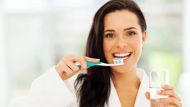Woman brushing teeth | Narre warren dentist