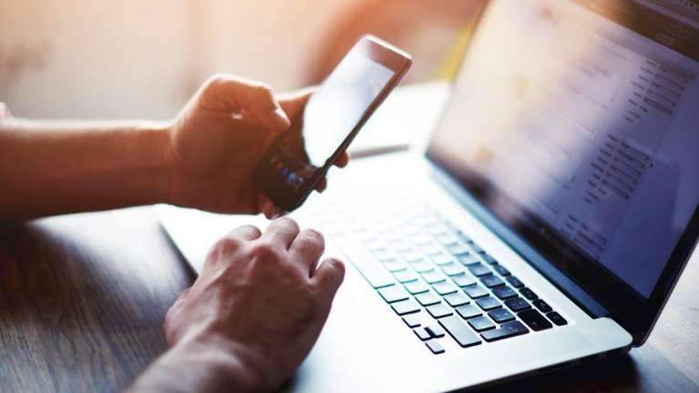 Person at computer doing dental finances | Narre Warren Dentist
