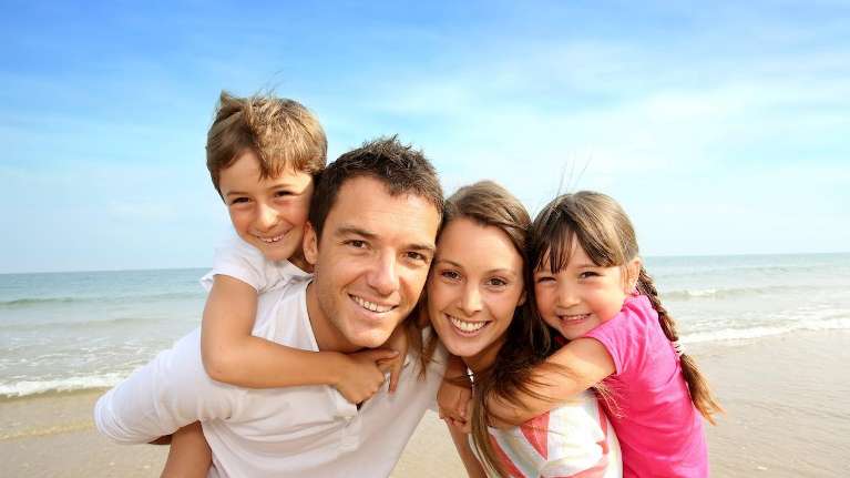 family of four on beach | dentist narre warren