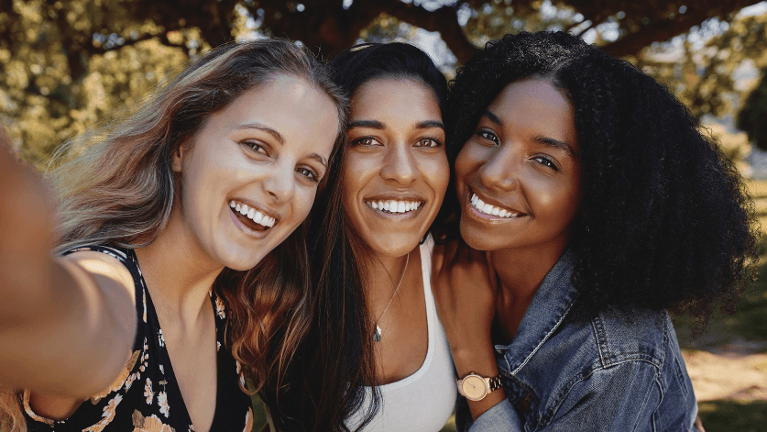 three women smiling | dentist near me