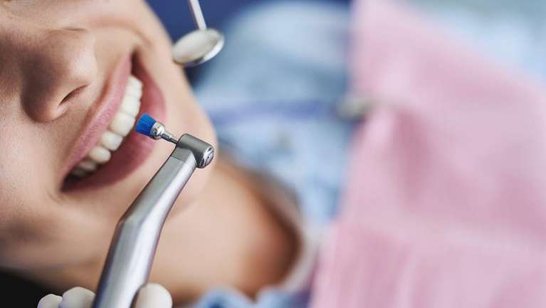 dental cleaning narre warren | woman receiving dentist exam