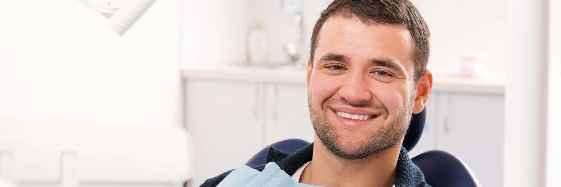man sitting in dentist exam chair | emergency dentist narre warren