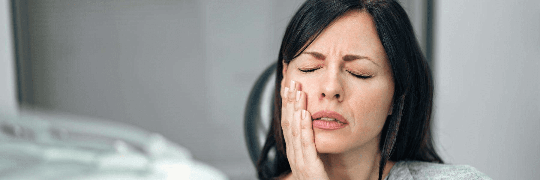 woman in pain holding jaw | root canal treatment narre warren